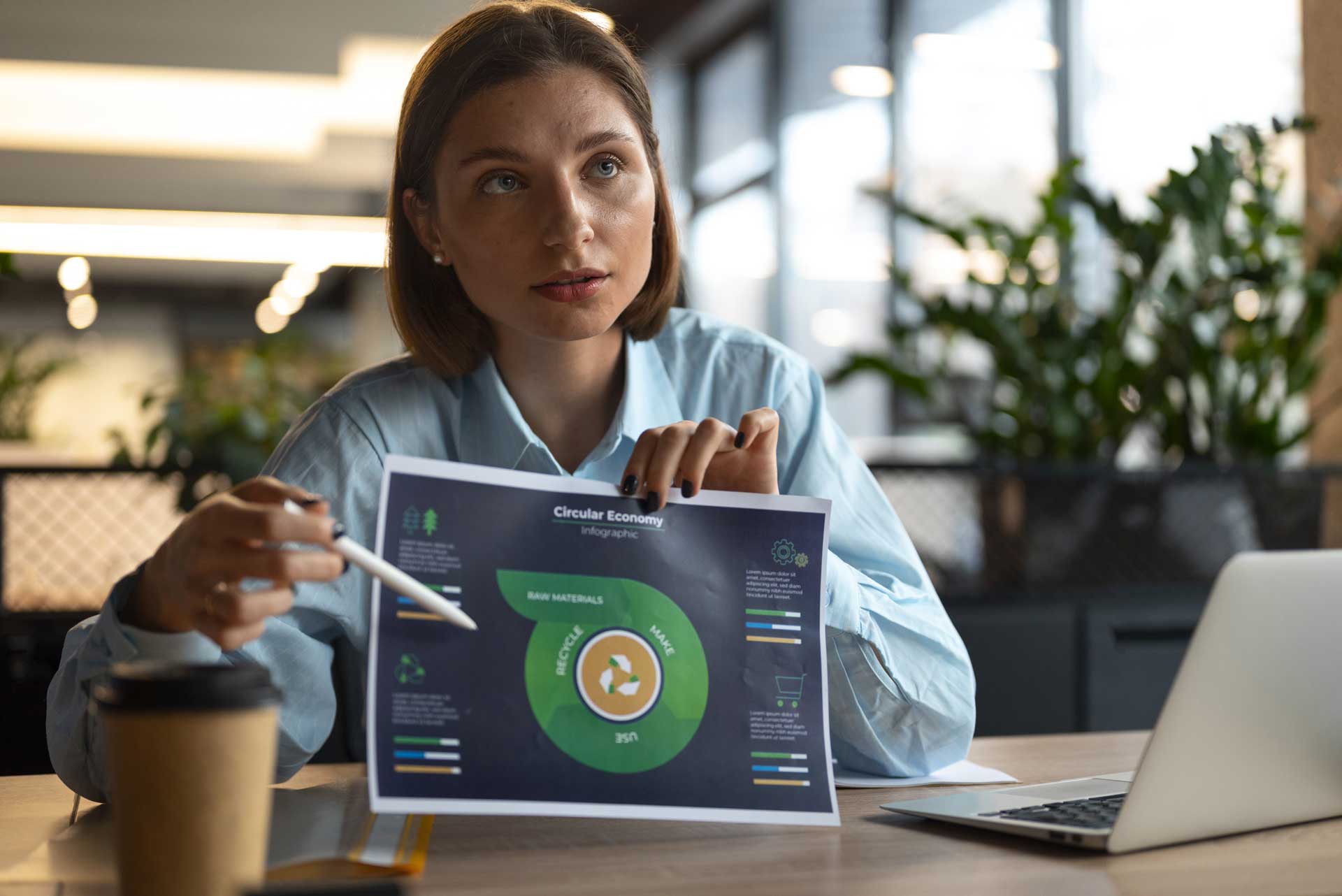 Professionnelle analysant un diagramme d’économie circulaire pour orienter une stratégie de développement durable.